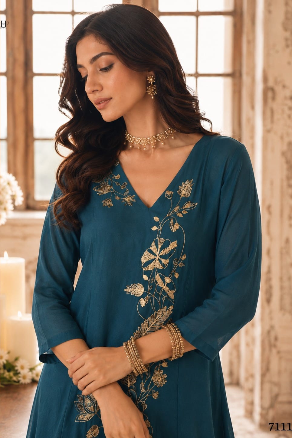 Close-up of teal engagement dresses for women kurta with gold zari and sequin work on the V neckline and three-quarter sleeves.