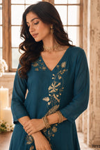 Close-up of teal engagement dresses for women kurta with gold zari and sequin work on the V neckline and three-quarter sleeves.