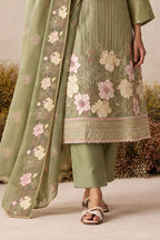 Waist-down detail view of a sage green pakistani suits style kurta pant set with floral thread embroidery on kurta hem and embroidered dupatta.