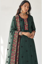 
Close-up of the dark green kurta for wedding neckline and bodice showing dense thread, sequin and zari embroidery with the sheer dupatta on the shoulder.