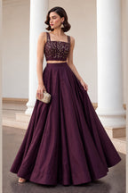 Front view of the Burgundy lehenga choli designs, displaying the flared soft silk lehenga skirt and embroidered sleeveless choli.