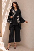 Full-length front view of a black indian co ord set, embroidered kurta with white floral embroidery and wide-leg pant in natural crape.