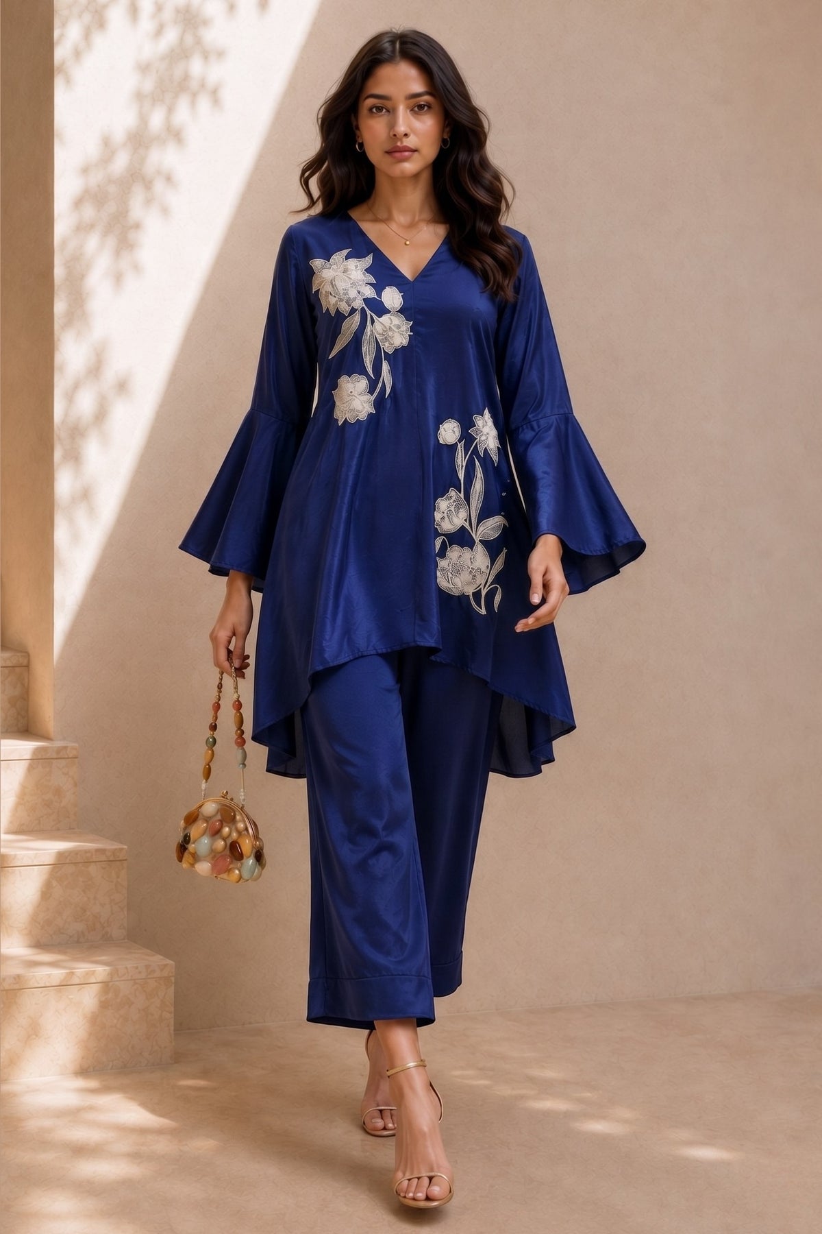 Full-length side view of a royal blue engagement dresses for women co ord set, embroidered kurta with flared sleeves and wide-leg pant.