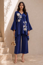 Woman wearing a royal blue indian co ord set, an embroidered kurta with wide-leg pant in natural crape, full-length front view.