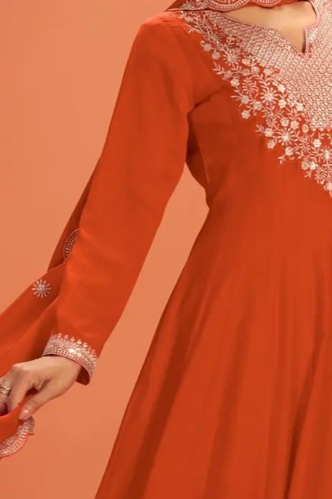 Torso detail view of a neon orange anarkali dress in premium silk with sequin and thread embroidery on the bodice and dupatta.