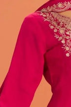 Close-up of the neckline embroidery on a pinkish red anarkali for wedding outfit in premium silk with sequin and thread work.
