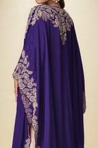 Back close-up view of a purple plazo with suit outfit showing gold embroidery detail across the cape shoulders and long sleeves.
