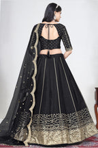 Full-length back view of a black wedding lehenga with an open back choli with dori tie and mirror work on the back. All-over mirror work.