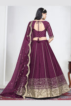 Full-length back view of a wine purple lehenga with mirror work with an open back choli with dori tie. All-over mirror work.