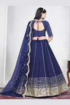 Full-length back view of a navy blue wedding lehenga with an open back choli with dori tie and mirror work. All-over mirror work.