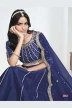 Close-up view of a navy blue lehenga with mirror work showing detailed mirror, sequin and thread work on the art silk choli.