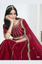 Close-up view of a red lehenga with mirror work showing detailed mirror, sequin and thread work on the art silk choli. All-over mirror work.