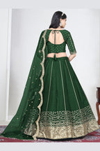 Full-length back view of a green wedding lehenga with an open back choli with dori tie and mirror work on the back. All-over mirror work.