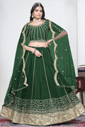 Woman wearing a green mirror lehenga with mirror work, half sleeve round neck art silk choli, full-length front view. All-over mirror work.