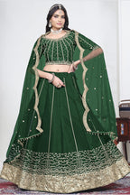 Woman wearing a green mirror lehenga with mirror work, half sleeve round neck art silk choli, full-length front view. All-over mirror work.