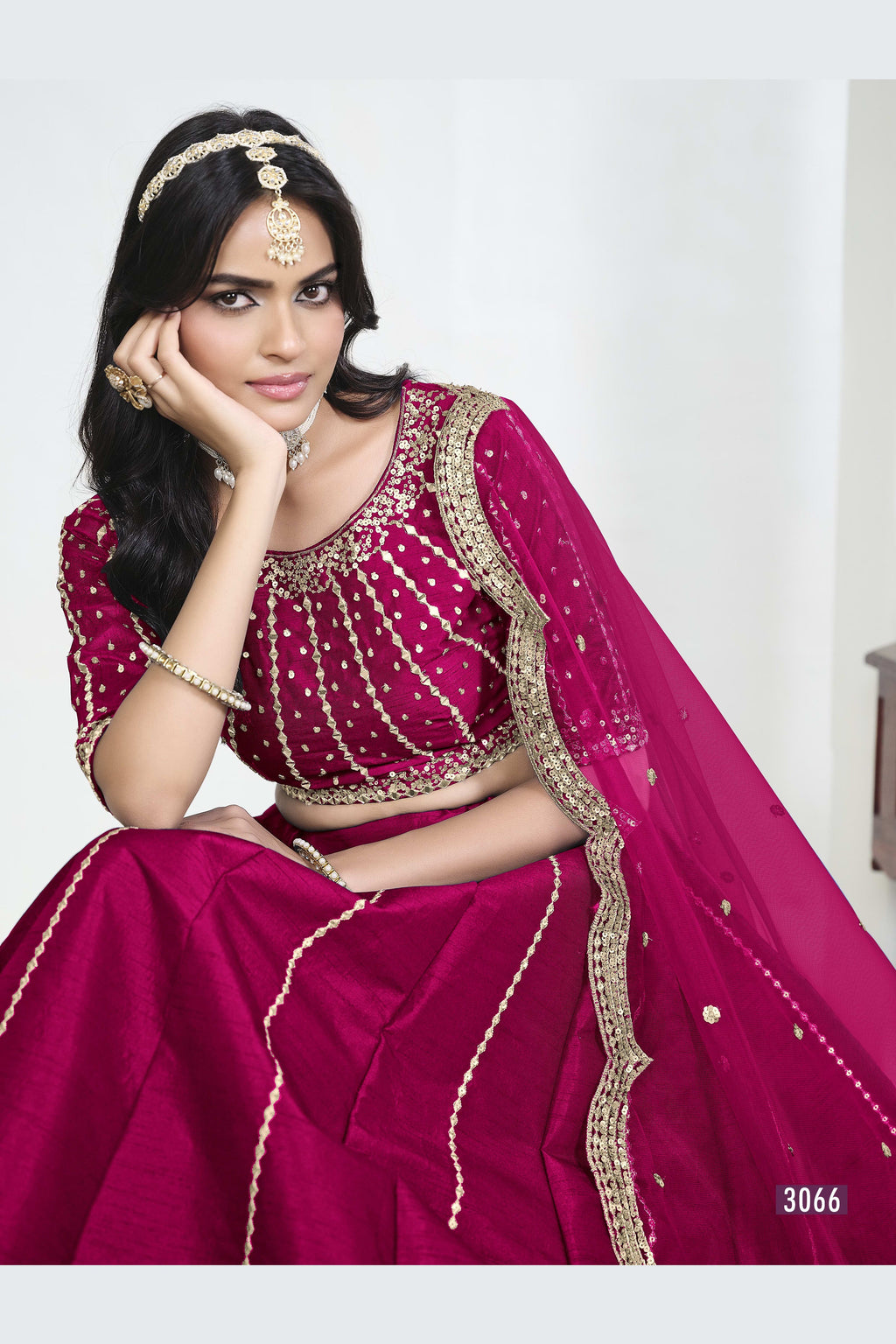Close-up view of a pink lehenga skirt with mirror work showing detailed mirror, sequin and thread work on the art silk choli.