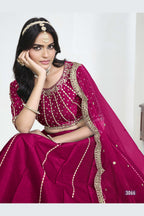 Close-up view of a pink lehenga skirt with mirror work showing detailed mirror, sequin and thread work on the art silk choli.