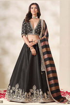 Black lehenga for wedding, shown in a full front view, featuring thread and sequins embroidery work on art silk with viscose dupatta.