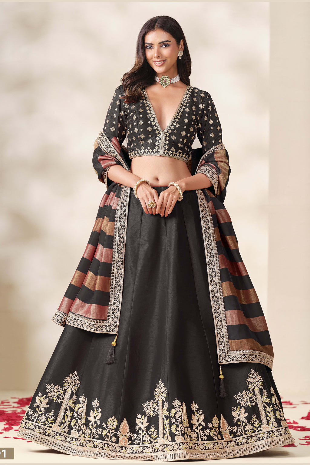 Black embroidered lehenga, shown in a three-quarter front view, featuring thread and sequins embroidery work on art silk with viscose dupatta.