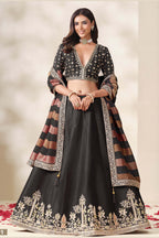 Black embroidered lehenga, shown in a three-quarter front view, featuring thread and sequins embroidery work on art silk with viscose dupatta.