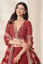 Red lehenga for sangeet, close-up of the lehenga skirt embroidery and sequin work, featuring thread and sequins embroidery work on art silk with viscose dupatta.