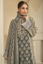 Close-up of a greenish grey palazzo suit bodice in crepe silk with hand aari work and gota patti work on the neckline and three-quarter sleeves.