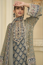 Close-up of a greenish grey palazzo suit bodice in crepe silk with hand aari work and gota patti work on the neckline and three-quarter sleeves.