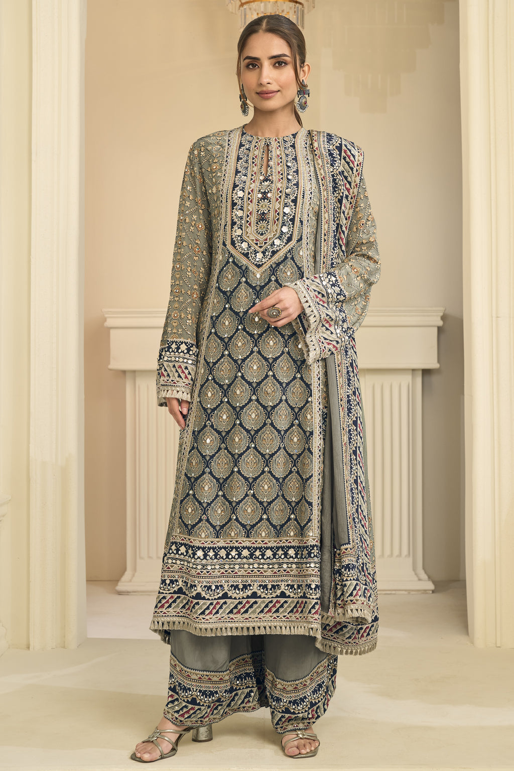 Another full-length front view of a greenish grey indian wedding guest dresses style plazo suit in crepe silk with hand aari work and gota patti work.