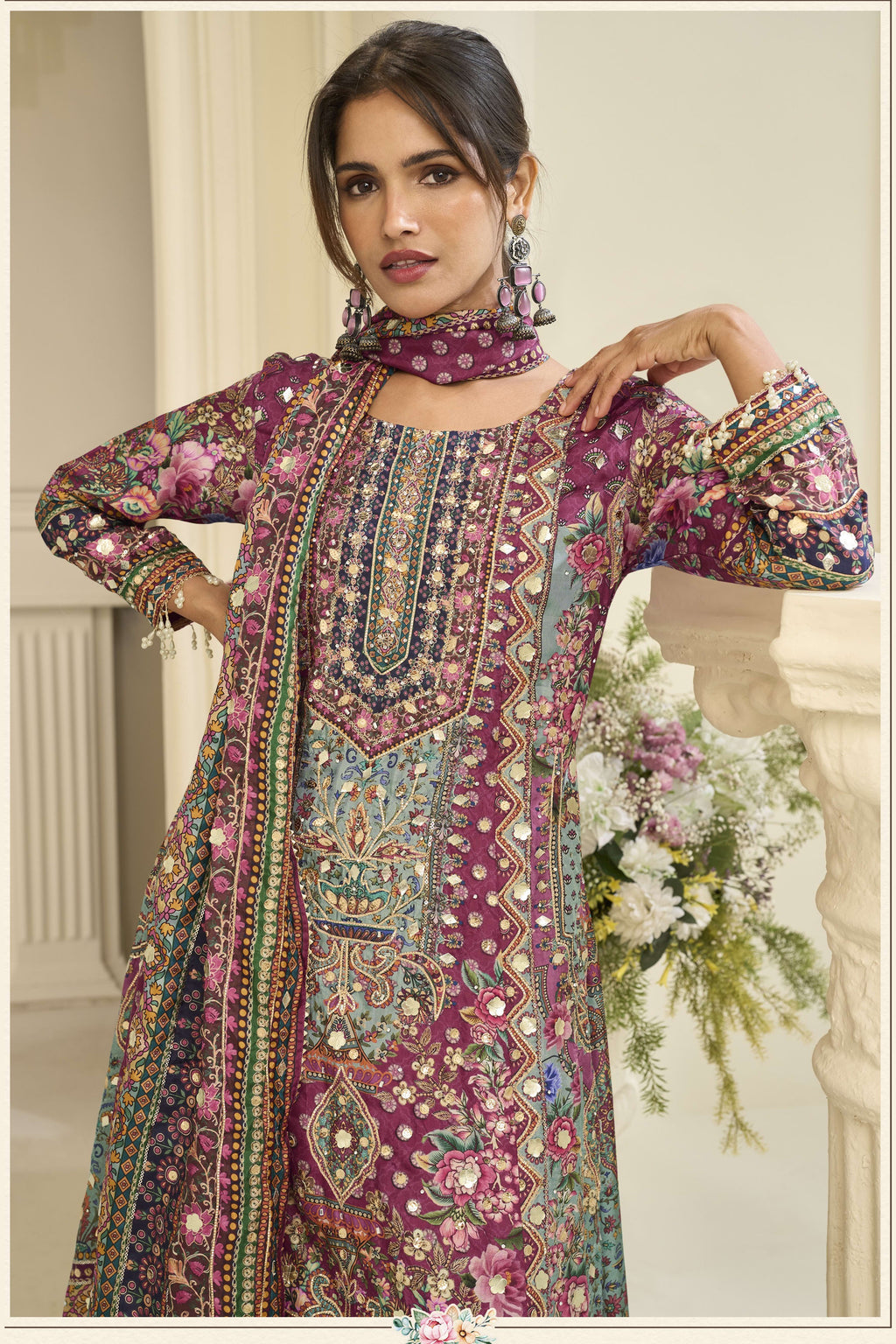 Close-up of a maroon palazzo dress bodice in crepe silk with hand aari work and gota patti work on the neckline and three-quarter sleeves.