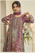 Close-up of a maroon palazzo dress bodice in crepe silk with hand aari work and gota patti work on the neckline and three-quarter sleeves.