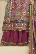 Lower-body detail of a maroon festive wear for women plazo suit in crepe silk with hand aari work and gota patti work on the kameez hem and printed plazo.