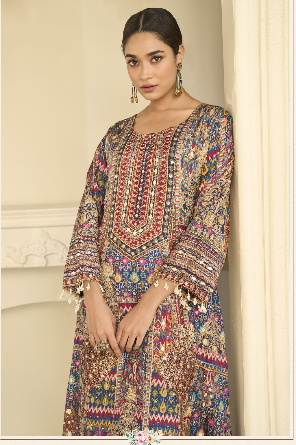 Close-up of a navy blue indian wedding guest dresses style plazo suit bodice in crepe silk with hand aari work and gota patti work on the neckline and sleeves.