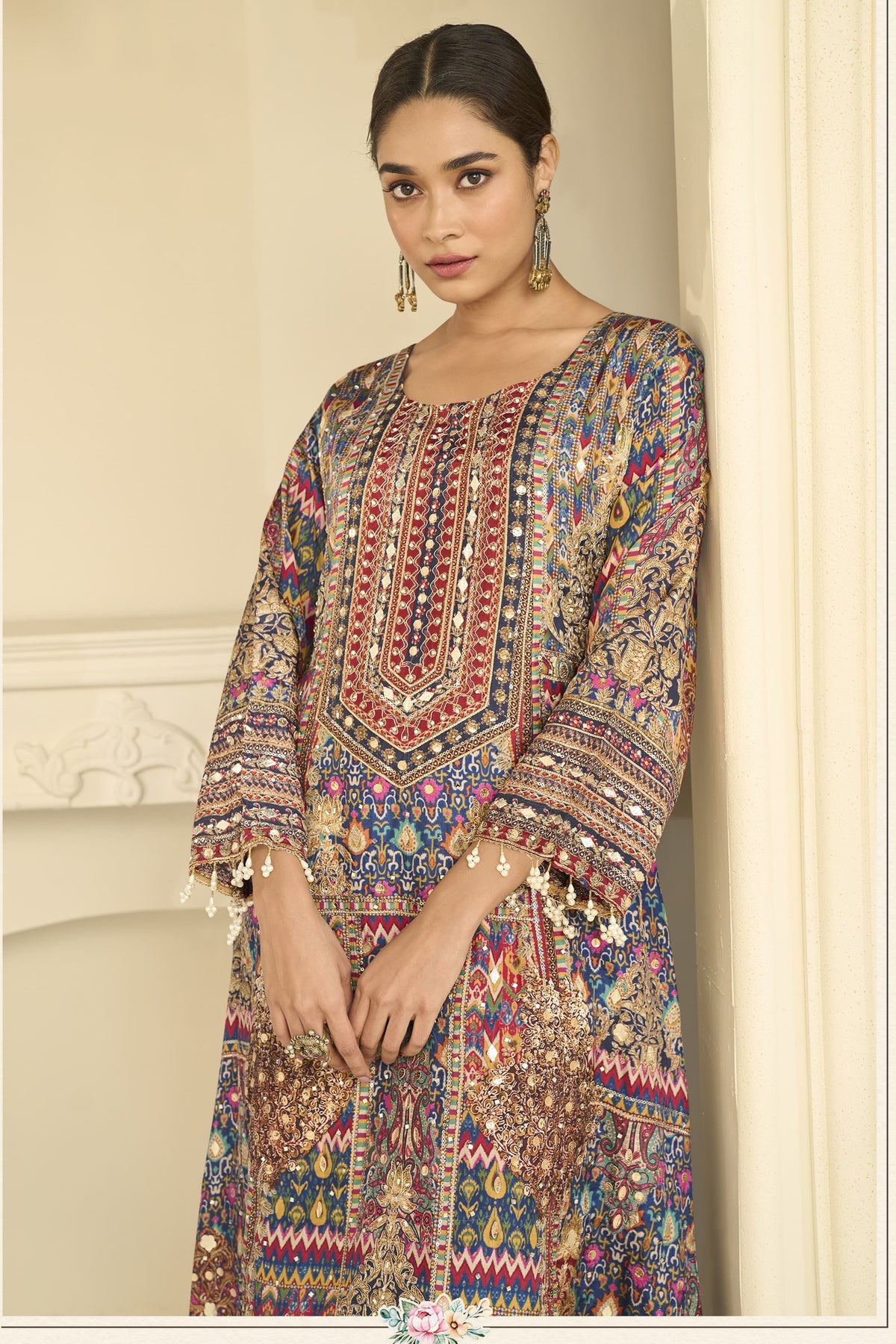 Close-up of a navy blue indian wedding guest dresses style plazo suit bodice in crepe silk with hand aari work and gota patti work on the neckline and sleeves.