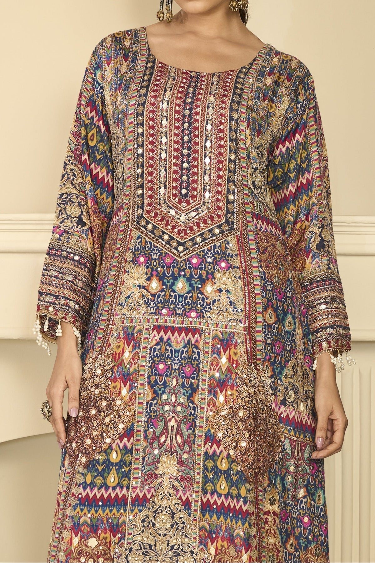 Upper-body view of navy blue mehndi outfits style plazo suit in crepe silk with hand aari work and gota patti work on the neckline and three-quarter sleeves.