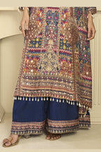 Lower-body detail of a navy blue palazzo dress plazo suit in crepe silk with hand aari work and gota patti work on the kameez hem and printed plazo.