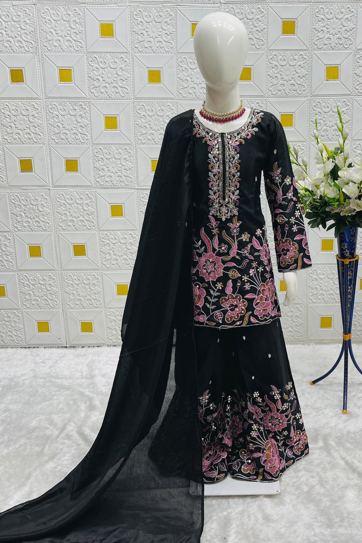 Black girls plazo suit on mannequin, front view displaying pink thread embroidery and sequin work across the kameez.