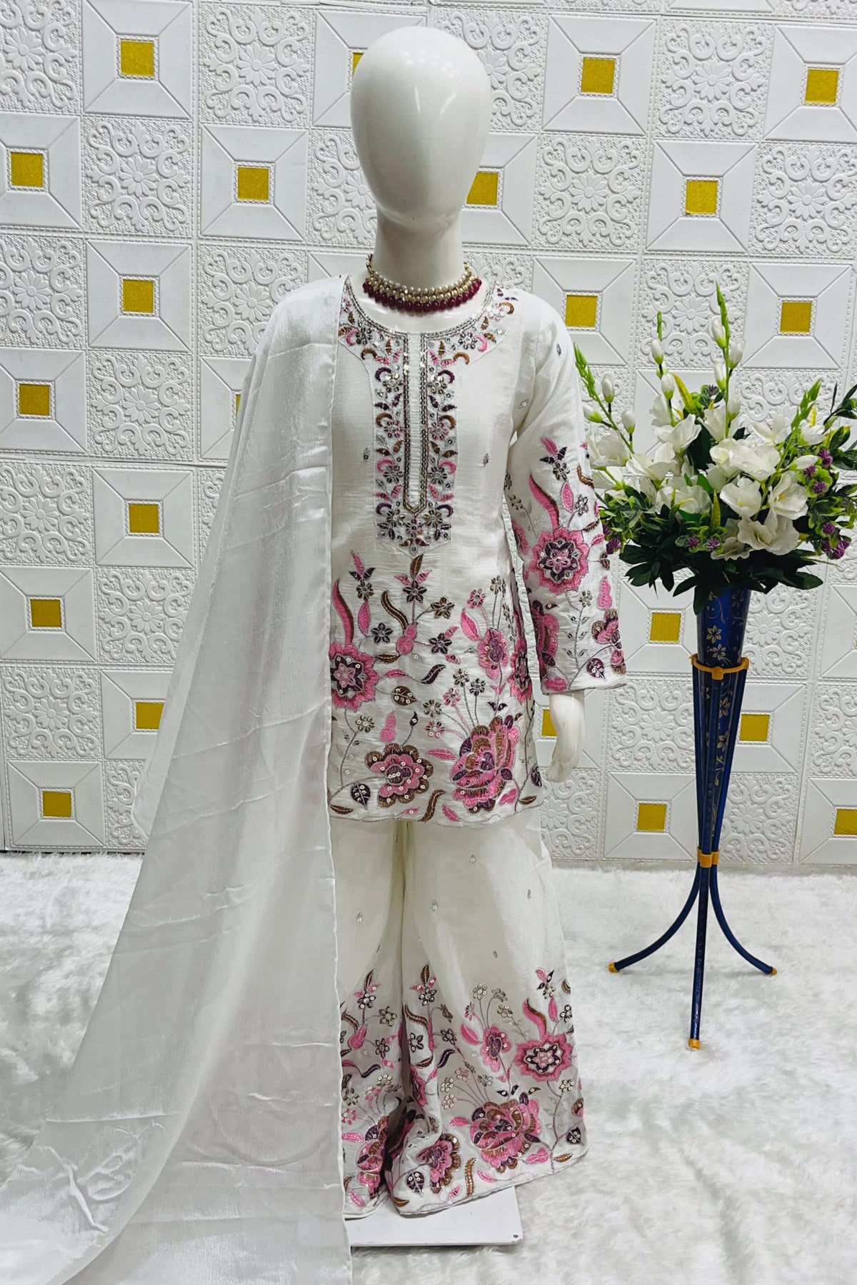 Off White ethnic kidswear kameez plazo set on mannequin, front view showing sequin embroidered chinon silk kameez.