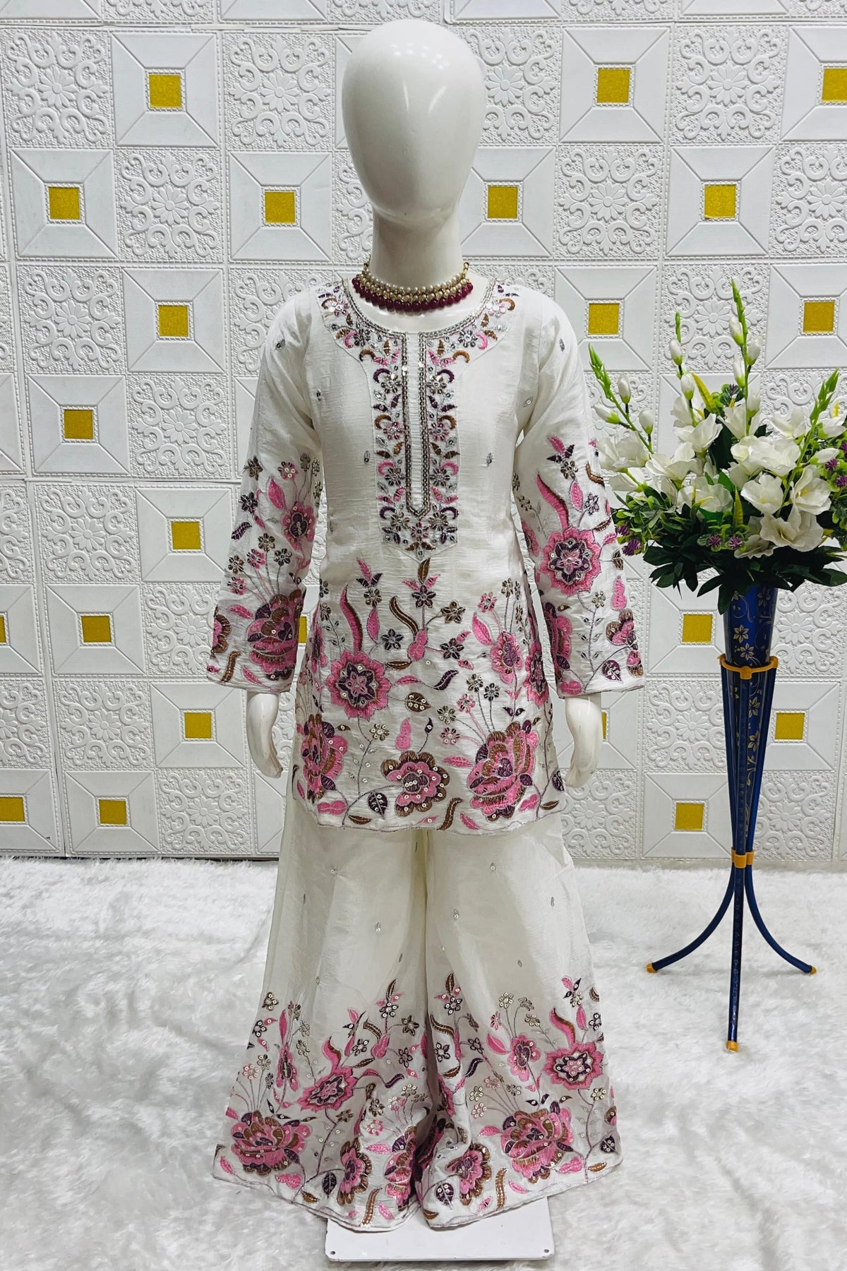 Off White kids plazo suit on mannequin, three-quarter view displaying pink thread and sequin floral embroidery.