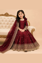 Maroon indian kidswear anarkali on mannequin, three-quarter view showing zari border work.