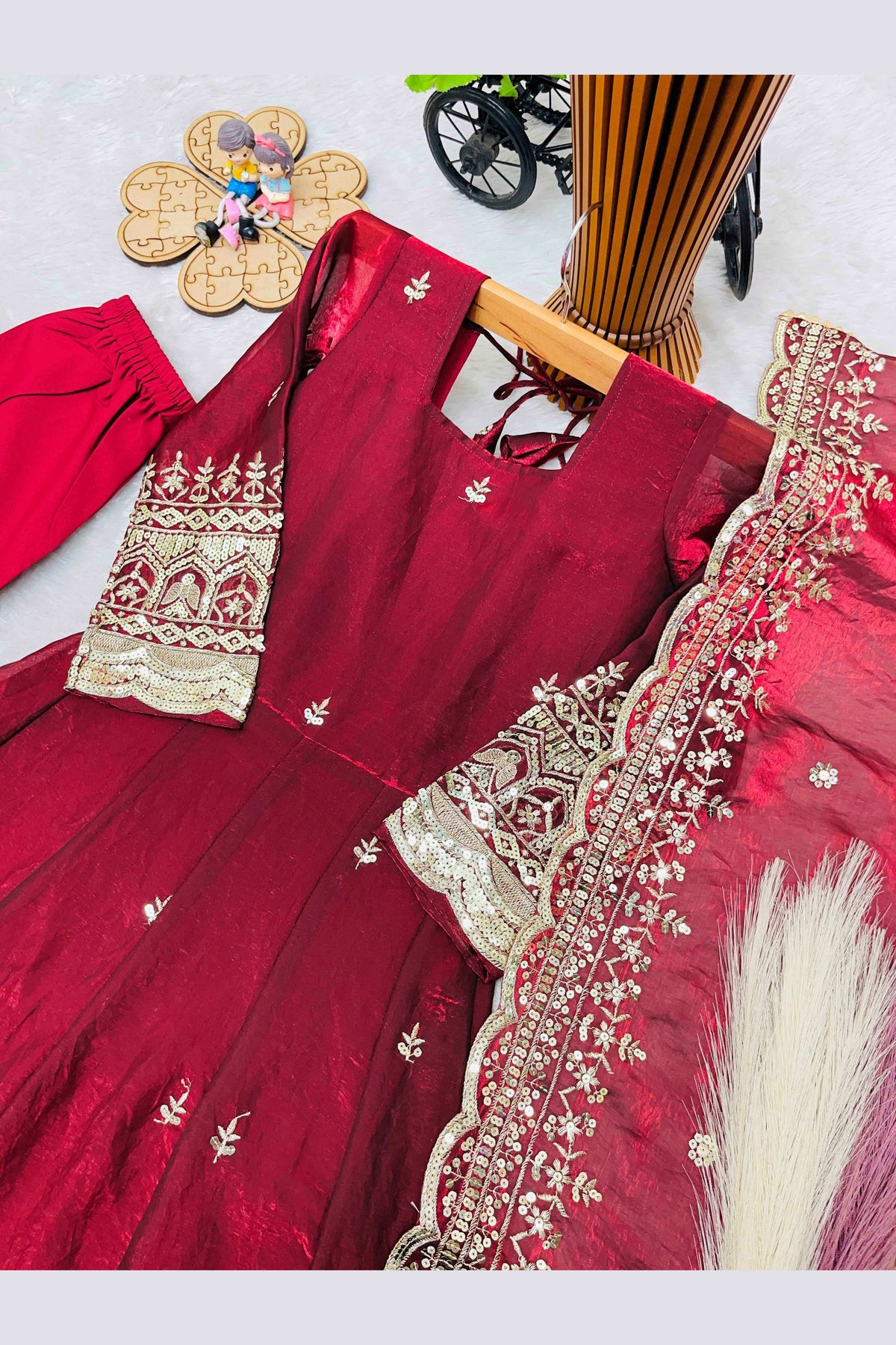 Close-up of maroon anarkali sleeve, sequins and zari embroidery on fendy silk cuff.