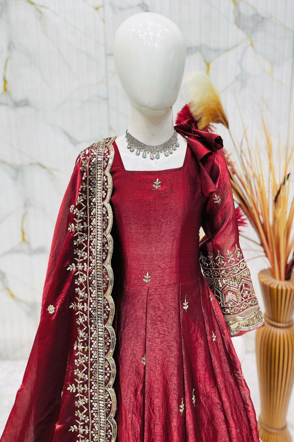 Maroon ethnic kidswear anarkali flat lay, complete set with cotton pant and fendy silk dupatta.