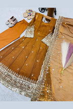 Mustard kids anarkali suit on model, side view showing flared silhouette with sequin detailing.