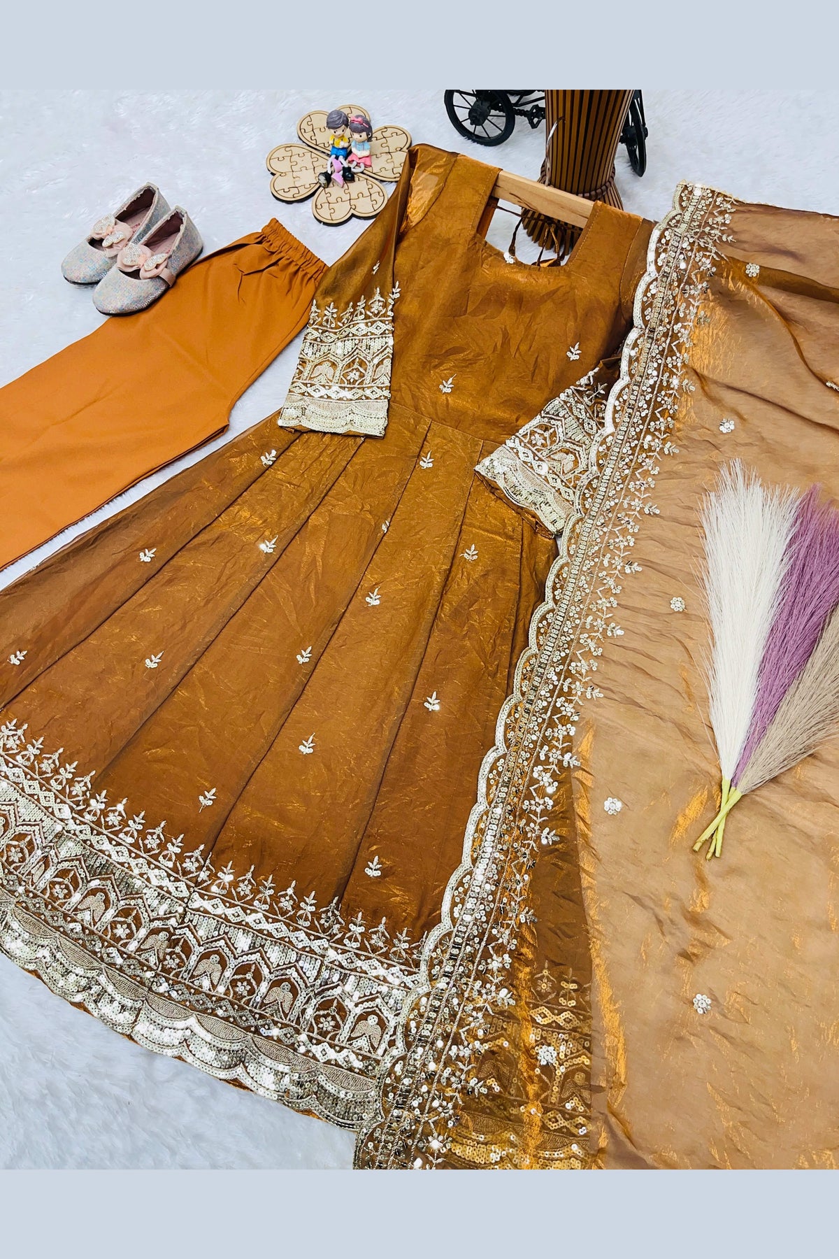 Mustard kids anarkali suit on model, side view showing flared silhouette with sequin detailing.