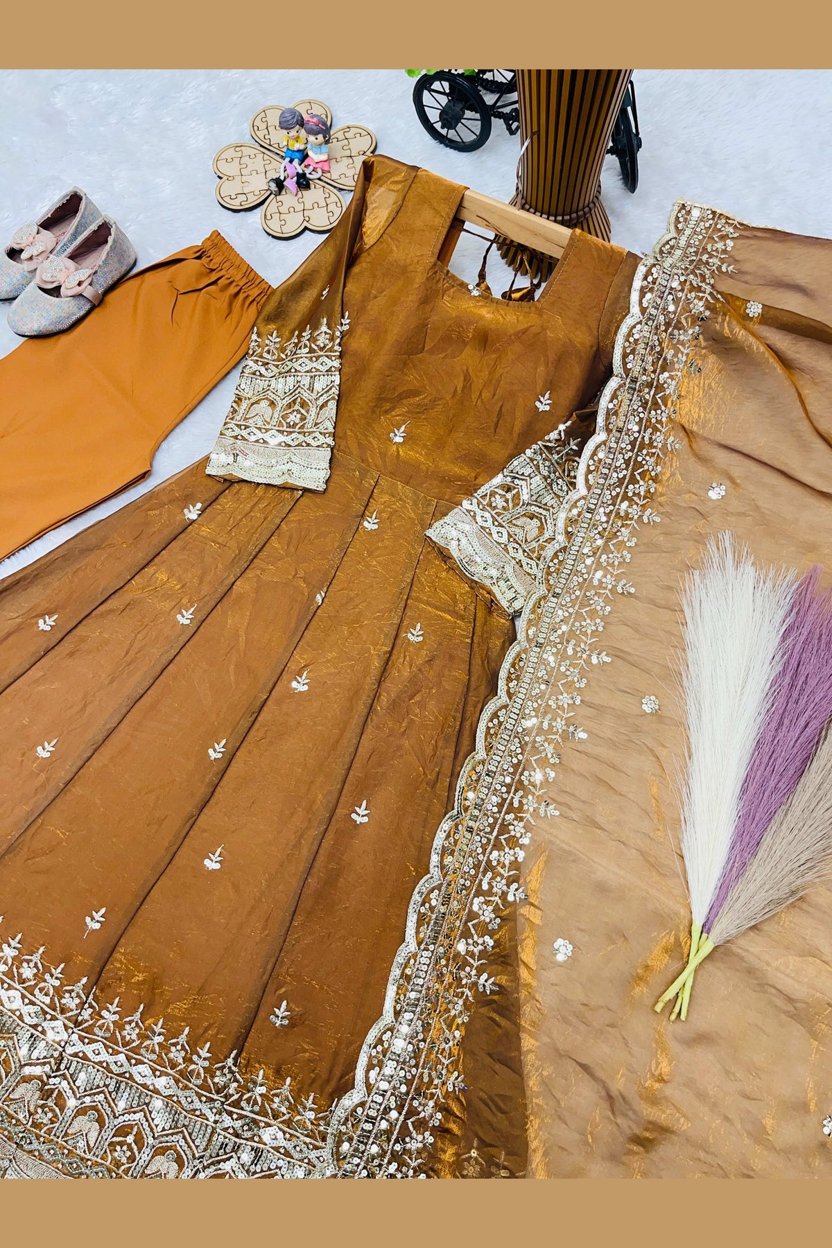 Flat lay of mustard anarkali skirt panel, sequin and zari work on fendy silk.