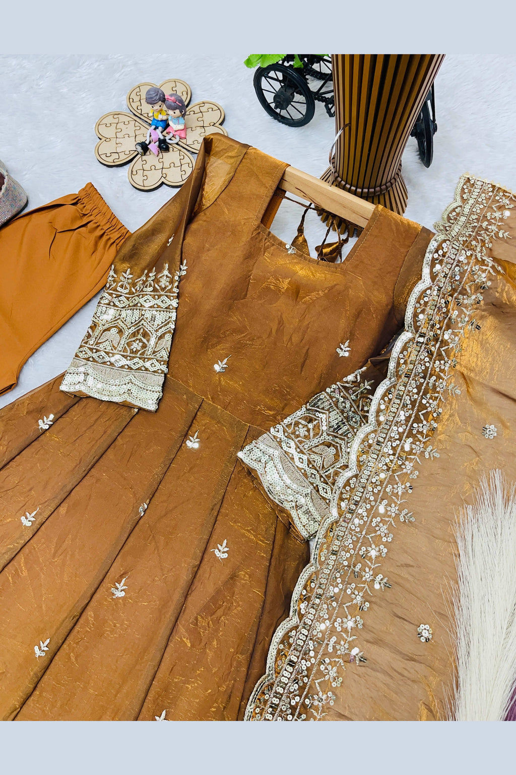 Close-up of mustard anarkali hemline, sequins and zari embroidery detail.