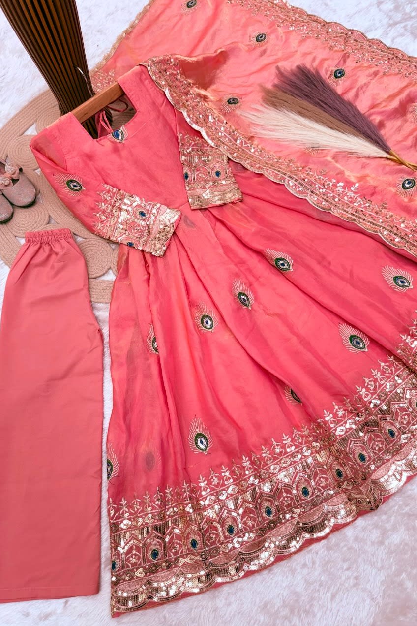 Coral pink childrens indian costume anarkali set flat lay, alternate angle showing the full embroidered three-piece set.