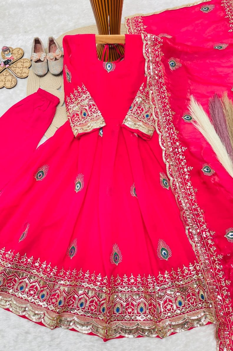 Reddish pink childrens indian costume girls anarkali set flat lay with embroidered top and fendy silk dupatta.