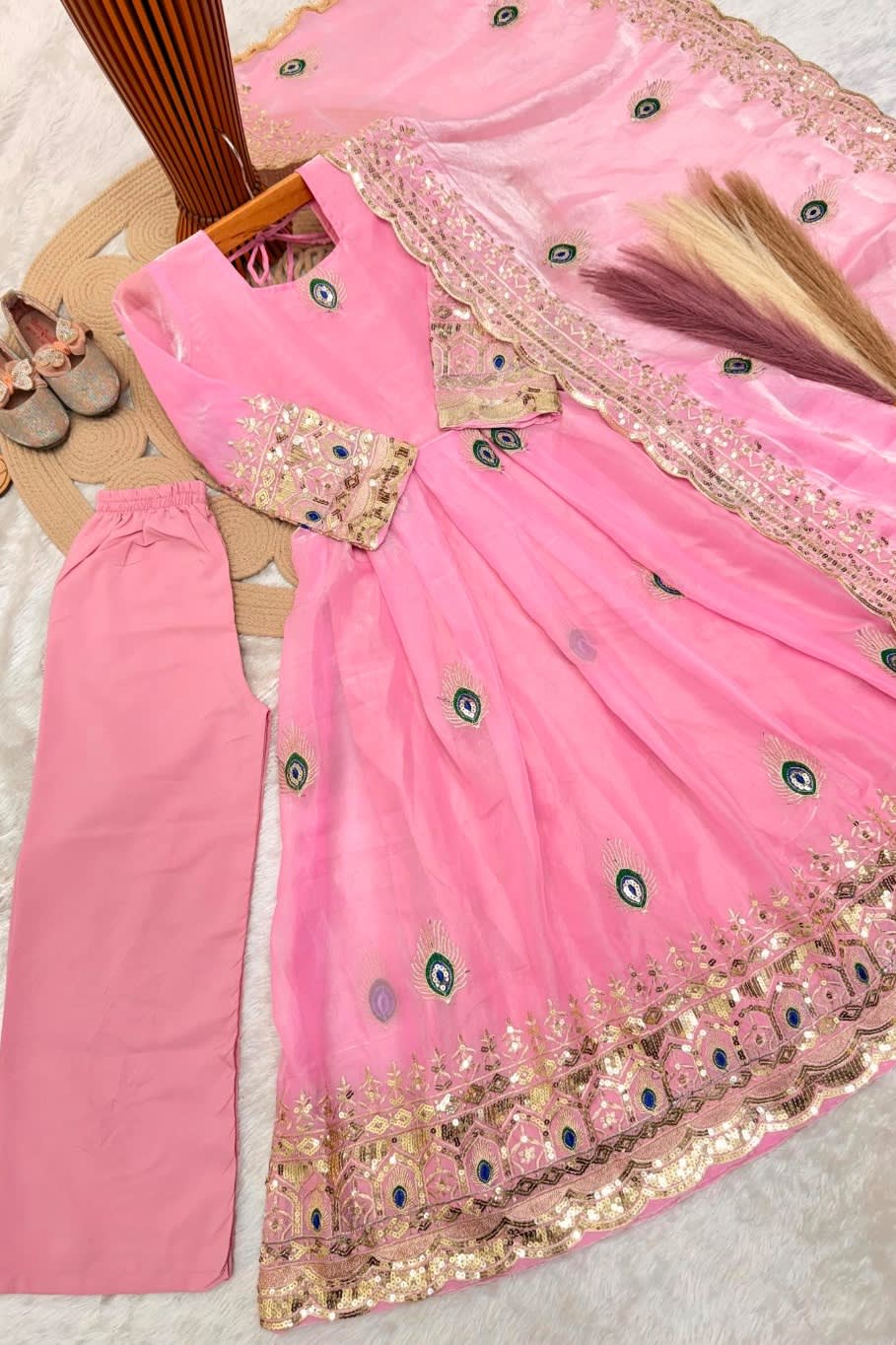 Light pink childrens indian outfits anarkali set flat lay, alternate angle showing the embroidered top and dupatta.