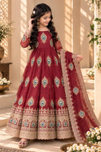 Girl wearing a red childrens indian outfits anarkali set with peacock feather embroidery, full-length front view.