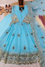 Sky blue childrens indian outfits girls anarkali set flat lay with cotton pant and embroidered fendy silk dupatta.